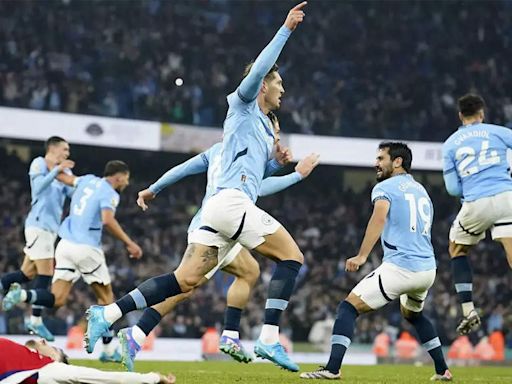 Premier League: John Stones strikes late to salvage point for Man City against 10-man Arsenal | Football News - Times of India