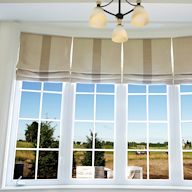 Roman shades are a classic and elegant type of window shade. They are made of fabric that folds up in horizontal pleats when raised. Roman shades are available in a variety of materials, including light filtering, blackout, and thermal options. They offer a soft, luxurious look and can be customized with different patterns and colors.