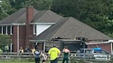Police responding to dump truck crashing into house