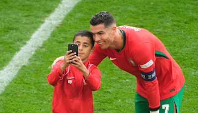 ‘Not the right way’: Selfie-hunting Ronaldo fans invade pitch at Euro match