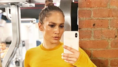 Jennifer Lopez, 55, shows off her washboard abs in yellow top and leggings