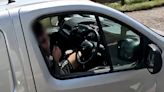 Shocking moment motorway driver is caught trimming his beard
