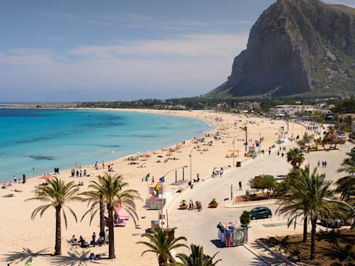 Pretty European beach compared to Rio de Janeiro with huge mountain & soft sands