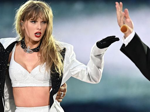 Travis Kelce Joins Taylor Swift Onstage for Surprise Appearance at Eras Tour Show - E! Online