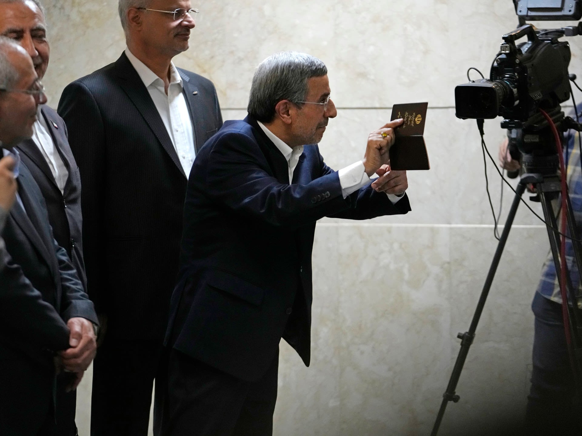 Iran’s ex-president Ahmadinejad, disqualified Larijani sign up for election