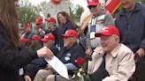 Southern Nevada veterans greeted by students with roses at WWII Memorial in Washington D.C.