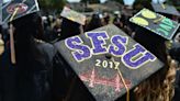 Graduates show their college futures on their caps as they make their way into the stadium for the commencement ceremony for the class of 2017 of Alameda High School in Alameda, California, on June 9, 2017.