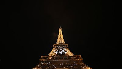 Eiffel Tower evacuated after man climbs up to Olympic rings