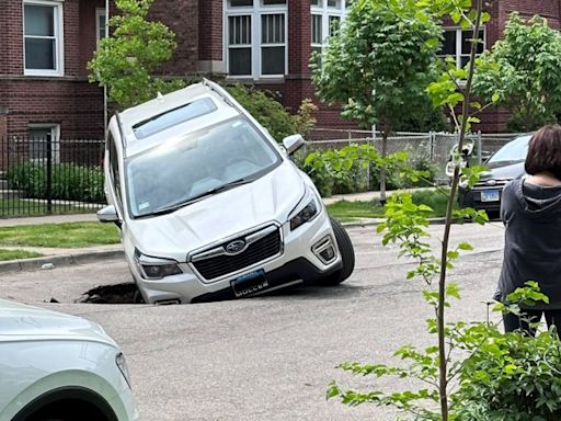 SUV falls into Uptown sinkhole