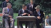 On this day in history, July 26, 1990, President George H.W. Bush signs Americans with Disabilities Act