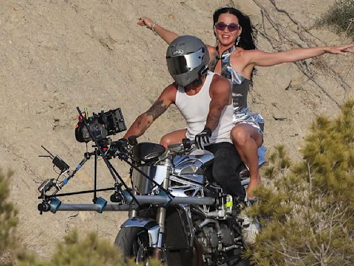 Katy Perry rides pillion on a motorbike while shooting her new video