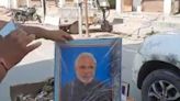 Sanitation worker fired after video shows him carrying portrait of Indian PM in trash cart