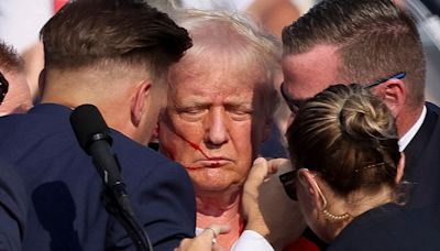 Dramatic photos capture the moments Trump is attacked and rushed off the stage