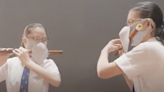 Hong Kong video showing double masked schoolchildren playing the flute draws ridicule