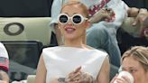 Ariana Grande Embraces 1960s Styling in White Boatneck Dress and Statement Sunglasses at 2024 Paris Olympics with Cynthia Erivo and Baz Luhrmann