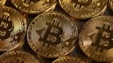 Bitcoin soars to record high, then tumbles