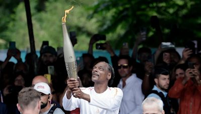 Snoop Dogg adds sizzle to Paris drizzle by carrying Olympic torch ahead of opening ceremony