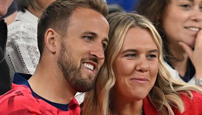 Harry Kane cuddles his wife after a nervy win over Serbia