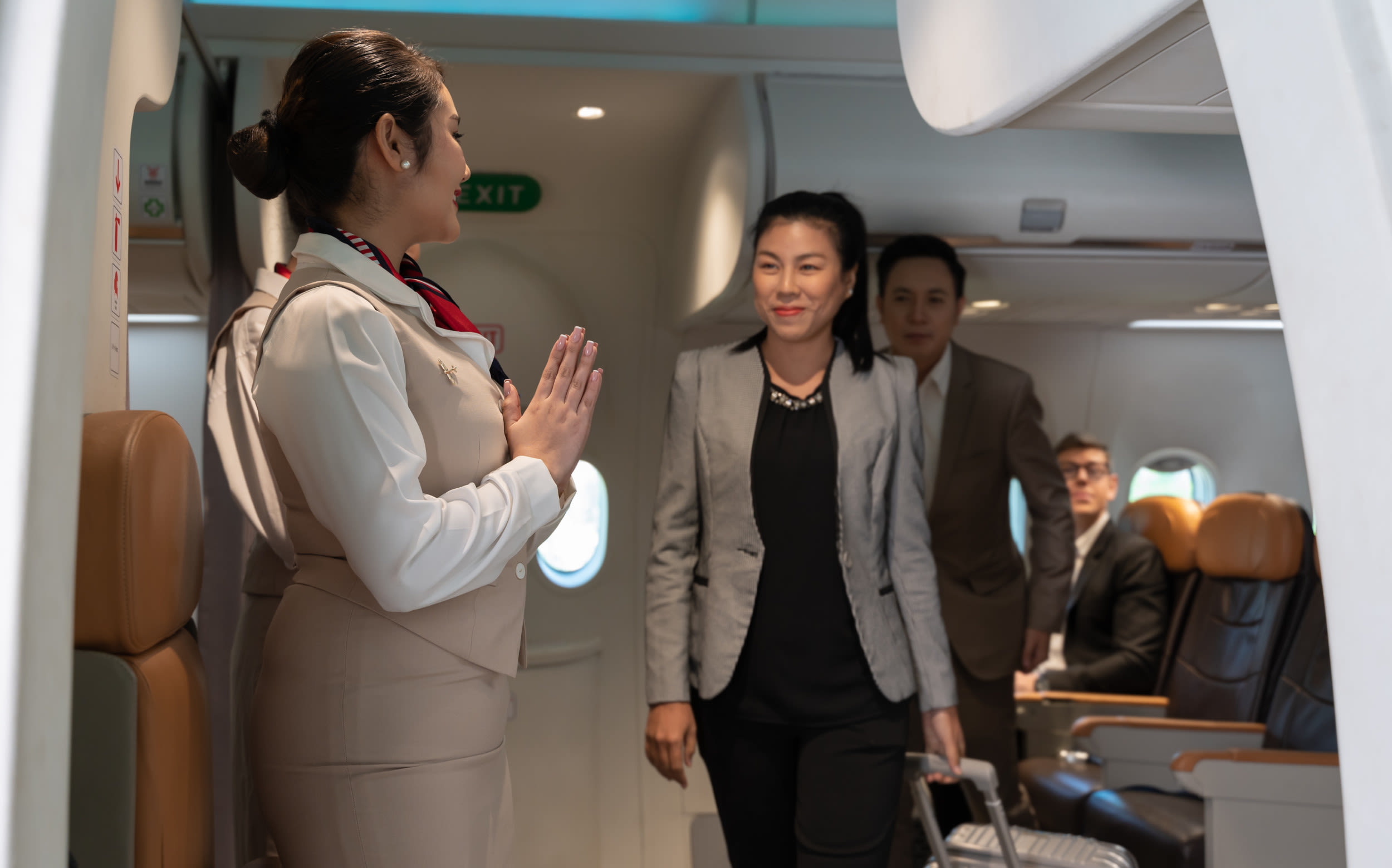 Flight attendant greeting passengers shocked to discover who's on board