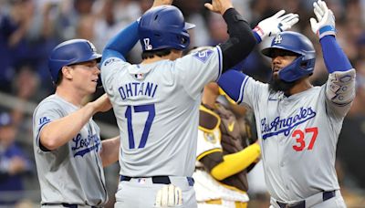 The Los Angeles Dodgers' Will Smith, left, and Shohei Ohtani congratulate Teoscar Hernandez after his grand slam during the sixth inning against the San Diego Padres...