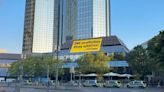 Greenpeace activists climb Deutsche Bank HQ in climate protest