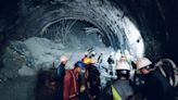 Rescuers dig to reach 40 workers trapped in collapsed road tunnel in north India