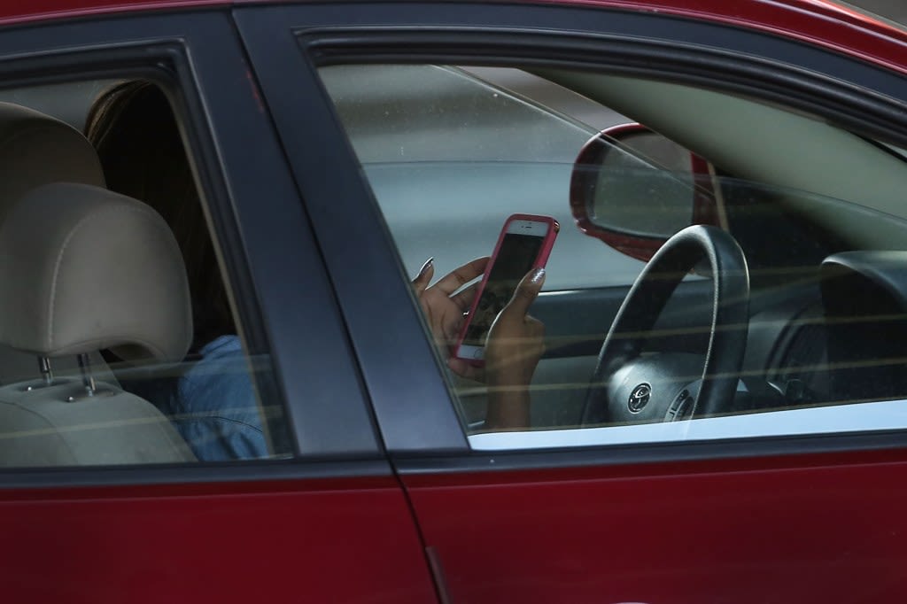 Colorado governor signs law banning hand-held use of phones while driving