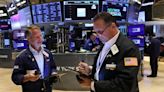 Wall St holds gains after cooler inflation, mixed earnings