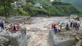 Rescuers search for dozens missing after flooding and a bridge collapse in China kill at least 25
