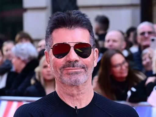 Simon Cowell is a proud dad as he cuddles mini-me son Eric, 10, on red carpet alongside fiancée Lauren Silverman