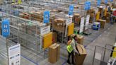 An Amazon worker moves a package at an Amazon delivery station on Nov. 28, 2022, in Alpharetta, Georgia.