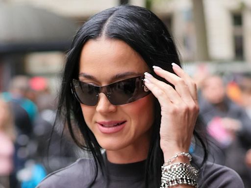Katy Perry covers up in a quirky black ensemble as she heads to radio