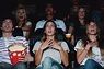 Audience in movie theater with shocked expressions - Stock Photo - Dissolve