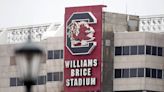 Legendary coach’s wife fell on an escalator at USC’s stadium. A lawsuit was settled for $1M
