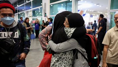 Flight carrying 123 Malaysians evacuated from Bangladesh arrives home