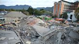 Rescuers contact some workers alive in the rubble of a deadly building collapse in South Africa