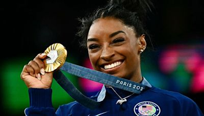 The United States' Simone Biles poses with her gold medal during the podium ceremony after the artistic gymnastics women's all around final during the Paris 2024 Olympic Games at the Bercy Arena...