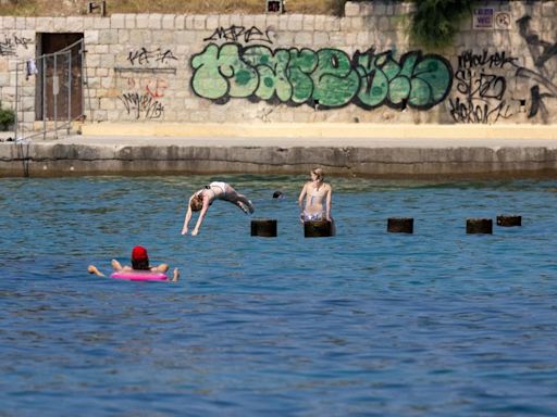 Tourists in Croatia seek refuge in warm Adriatic waters from heatwave