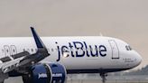 A JetBlue passenger says she was scalded by hot tea during turbulence and is suing for $1.5 million