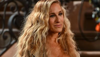 Sarah Jessica Parker almost spills out of busty corset while on set