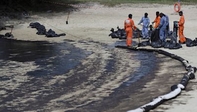 Singapore rushes to clean up oil slick after boat hits stationary fuel supply ship