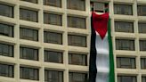 Protesters hang Palestinian flag from venue before Joe Biden's speech