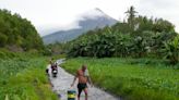 Rains unleashed by typhoon worry thousands of people fleeing restive Philippine volcano