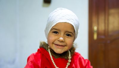 Celine, a little Syrian girl who can now hear, just like her big brother