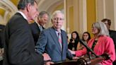 Mitch McConnell escorted away from cameras after freezing during a news conference