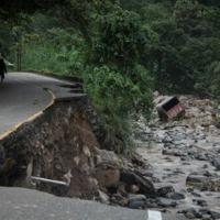 The floods damaged a road and swept away vehicles