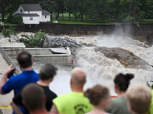 Part of a Minnesota home has plunged into the Blue Earth River as deadly Midwest flooding threatens the nearby Rapidan Dam