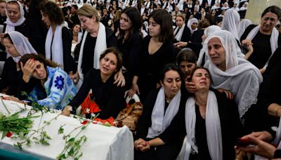 Mourners heckle Israeli ministers at funerals of 12 children killed by Hezbollah rockets