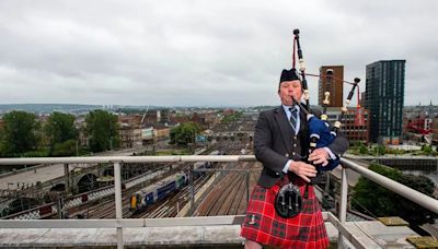 Brave piper scales roof of one of Scotland’s most historic train stations to honour armed forces