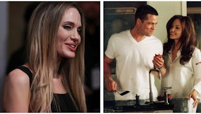 Angelina Jolie appears stoic as she autographs Mr and Mrs Smith poster featuring ex-husband Brad Pitt. Pics